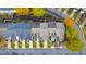 Aerial view of townhouses with fall foliage, driveways, and street parking at 247 Kigian Trl, Woodstock, GA 30188