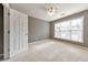 Cozy bedroom with a ceiling fan and neutral color scheme at 247 Kigian Trl, Woodstock, GA 30188
