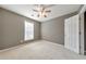 Bright bedroom with neutral walls, carpet, ceiling fan and window at 247 Kigian Trl, Woodstock, GA 30188