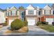 Townhouse exterior with attached garage and landscaping at 247 Kigian Trl, Woodstock, GA 30188