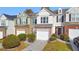 Townhouse exterior with attached garage and landscaping at 247 Kigian Trl, Woodstock, GA 30188