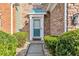 Inviting teal front door entrance with stonework and landscaping at 247 Kigian Trl, Woodstock, GA 30188