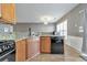 Modern kitchen featuring granite countertops and stainless steel appliances at 247 Kigian Trl, Woodstock, GA 30188
