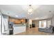Open kitchen with granite countertops, stainless steel appliances, and wood cabinets at 247 Kigian Trl, Woodstock, GA 30188