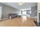 Living room with hardwood floors and gray walls, open to kitchen and dining at 247 Kigian Trl, Woodstock, GA 30188