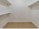 Empty walk-in closet with built-in shelving and tiled floor at 3 Rue Fontaine, Lithonia, GA 30038