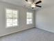 Well-lit bedroom featuring two large windows and carpet at 425 Collins Industrial Way, Lawrenceville, GA 30046