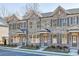 Brick townhouses with gray shutters and front porches at 425 Collins Industrial Way, Lawrenceville, GA 30046