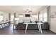 Open living room with dark gray sectional sofa, white coffee table, and ceiling fan at 4188 Waratah Way, Mableton, GA 30126