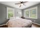 Bright bedroom with a king bed and large windows at 6650 Queen Mill Se Rd, Mableton, GA 30126