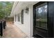 Front entrance with black door, white brick, and shutters at 6650 Queen Mill Se Rd, Mableton, GA 30126
