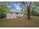 Back exterior view of ranch home with large backyard at 6650 Queen Mill Se Rd, Mableton, GA 30126