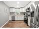 Modern kitchen with stainless steel appliances and white cabinets at 6650 Queen Mill Se Rd, Mableton, GA 30126