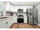 Modern kitchen with stainless steel appliances and white cabinets at 6650 Queen Mill Se Rd, Mableton, GA 30126