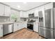 Modern kitchen with stainless steel appliances and white cabinets at 6650 Queen Mill Se Rd, Mableton, GA 30126