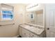 Bathroom with vanity, granite countertop and large mirror at 417 Tina Hely Ct, Stockbridge, GA 30281