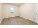 Simple bedroom with wood-look flooring and window at 417 Tina Hely Ct, Stockbridge, GA 30281