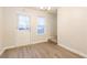 Dining room with wood-look floors, a door, large window, and carpeted stairs at 417 Tina Hely Ct, Stockbridge, GA 30281