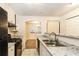 Updated kitchen featuring granite countertops and black appliances at 417 Tina Hely Ct, Stockbridge, GA 30281