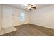 Bright living room featuring wood-look floors, a ceiling fan, and entryway access at 417 Tina Hely Ct, Stockbridge, GA 30281