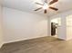 Spacious living room with wood-look flooring, ceiling fan, and view of the kitchen at 417 Tina Hely Ct, Stockbridge, GA 30281