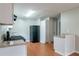 Efficient kitchen with white cabinets, black appliances, and light wood flooring at 4480 Joseph Dr, Snellville, GA 30039
