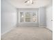 Well-lit bedroom with neutral walls and carpet at 2166 Leatherstone Dr, Powder Springs, GA 30127