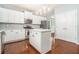 Modern kitchen with white cabinets, island, and stainless steel appliances at 2166 Leatherstone Dr, Powder Springs, GA 30127