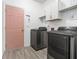 Laundry room with washer, dryer, and cabinets at 2166 Leatherstone Dr, Powder Springs, GA 30127