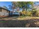 Large backyard with mature trees and sloping terrain at 3619 Colonial Trl, Douglasville, GA 30135