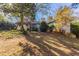 Landscaped backyard with mature trees and partial view of house at 3619 Colonial Trl, Douglasville, GA 30135