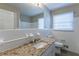 Clean bathroom with granite countertop, white cabinets, and a window with blinds at 3619 Colonial Trl, Douglasville, GA 30135
