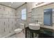 Updated bathroom with a tiled shower, vanity with vessel sink, and granite countertop at 3619 Colonial Trl, Douglasville, GA 30135