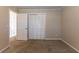Comfortable bedroom with neutral walls, carpet flooring, and ample closet space at 3619 Colonial Trl, Douglasville, GA 30135