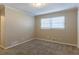 Well-lit bedroom with neutral walls, carpet flooring, and a window with blinds at 3619 Colonial Trl, Douglasville, GA 30135