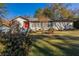 Ranch style home with red door, landscaping, and large yard at 3619 Colonial Trl, Douglasville, GA 30135