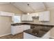 Eat-in kitchen with granite counters, white cabinets, and exposed beams at 3619 Colonial Trl, Douglasville, GA 30135