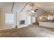 Open living room with vaulted ceiling, fireplace, and kitchen view at 3619 Colonial Trl, Douglasville, GA 30135