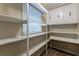 Well-stocked pantry with ample shelving and window at 3619 Colonial Trl, Douglasville, GA 30135