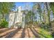 Exterior view of a two-story home with a wooded backyard at 4570 Latimer Ne Pointe, Kennesaw, GA 30144