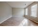 Bright bedroom with neutral walls and wood-look floors at 4320 Ward Bluff Ct, Ellenwood, GA 30294