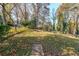 Spacious backyard with mature trees and stone path at 2715 Connally Sw Dr, Atlanta, GA 30311