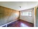 Simple bedroom with wood paneling and hardwood floors at 2715 Connally Sw Dr, Atlanta, GA 30311