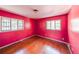 Bright bedroom with hardwood floors and two windows at 2715 Connally Sw Dr, Atlanta, GA 30311