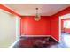 Dining room with dark hardwood floors and coral walls at 2715 Connally Sw Dr, Atlanta, GA 30311