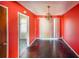 Dining room with dark hardwood floors and coral walls at 2715 Connally Sw Dr, Atlanta, GA 30311