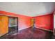 Large living room with dark hardwood floors and coral walls at 2715 Connally Sw Dr, Atlanta, GA 30311