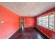 Spacious living room with dark hardwood floors and coral walls at 2715 Connally Sw Dr, Atlanta, GA 30311