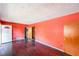 Living room with dark hardwood floors and coral walls at 2715 Connally Sw Dr, Atlanta, GA 30311