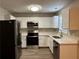 Modern kitchen with stainless steel appliances and white cabinets at 7069 Ravenwood Ln, Lithonia, GA 30038